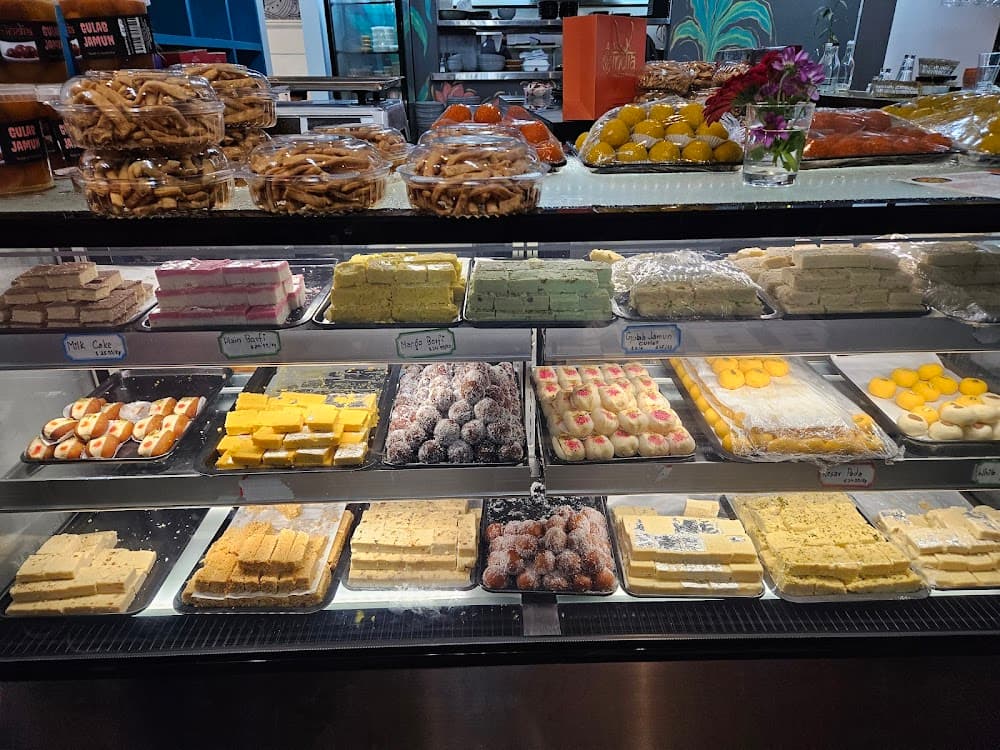 A cafe display cabinet stocked with fresh vegetarian Indian food