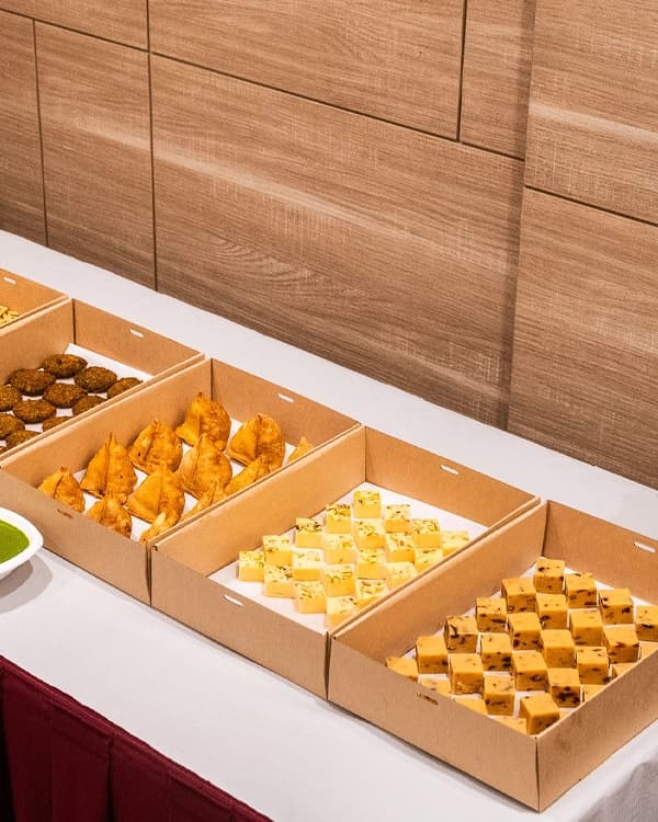 Individually packed vegetarian meal boxes ready for workplace delivery